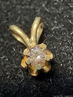 Front view of 10K gold pendant showing diamond and six prong setting