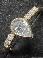 Ring angled showing pear diamond and side stones