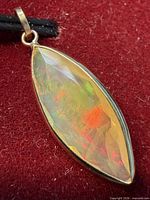 Front view of marquise faceted opal pendant in 10K yellow gold