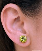 Peridot stud earring worn in ear