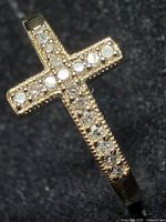 Close-up of diamond set cross head on ring