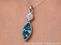 Pendant worn on chain showing size and colour.