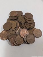 Pile of Canadian 1-cent coins showing obverse and reverse designs