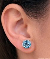 Earring worn on ear showing size and color
