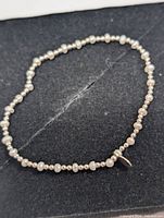 Full view of bracelet laid flat showing pearl and bead pattern