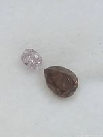 Close-up of two loose diamonds showing colour and cut
