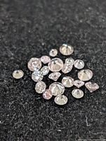 Group of loose pink diamonds on black background