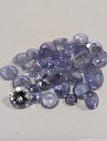 pile of mixed-cut violet tanzanite stones
