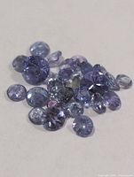 Cluster of round faceted violet-blue gemstones