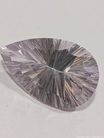 Top view of pear-shaped white topaz showing concave faceting