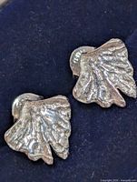 front view of both earrings showing leaf design