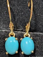 front view of both earrings showing turquoise stones and prong settings