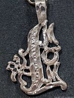 Front view of openwork silver pendant