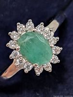 Front view showing emerald center and CZ halo