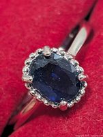 Front view showing sapphire and halo setting