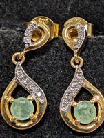 Front view showing 925 stamp, emerald stones, CZ accents