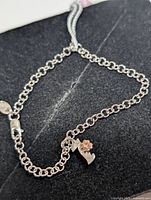 Full view of silver bracelet showing cable chain, clasp and diamond charm