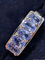 Angled top view showing six oval tanzanite stones in setting