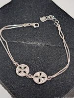 Full view of silver bracelet showing two CZ discs and lobster clasp