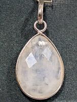Front view of pear-shaped moonstone pendant in silver setting