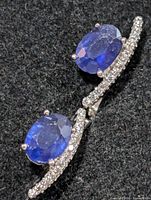 Front view showing both earrings with sapphire and CZ setting