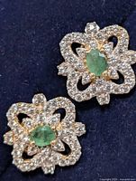 Front view showing emerald centres and CZ halo