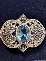 Front view showing blue topaz and marcasite detailing