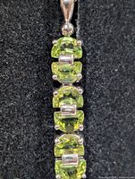 front view showing five peridot stones and silver spacers