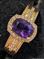 Top view showing amethyst centre stone, CZ halo, shoulder accents