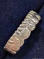 side view showing raised elephant figures and scalloped edge