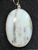 Front view of chalcedony pendant showing stone coloration and silver bezel