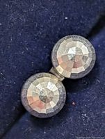 Close-up of faceted surface on one stud earring