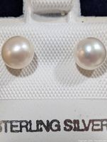front view of both pearl studs on display card