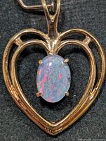 front view of heart pendant showing opal