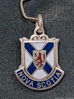Front view of silver pendant showing enamel crest and Nova Scotia banner