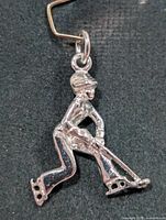 Front view of silver hockey player pendant
