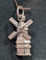 Front view of silver windmill pendant
