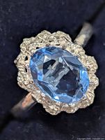 Top view of ring showing blue oval stone and textured silver setting