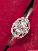 Close-up of ring front showing marquise center and side stones