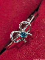 Front view showing bow design and blue stone