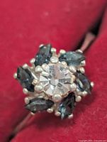 Front view of ring showing central clear stone and surrounding blue marquise stones