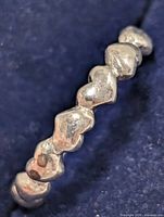 Close view of heart motifs on silver ring