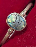 Front view of silver ring showing oval iridescent shell inlay and band detail