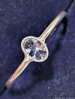 Top view showing oval tanzanite bezel set in silver-tone band