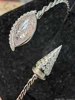 Close-up of navette and cone CZ terminals on twisted silver cuff