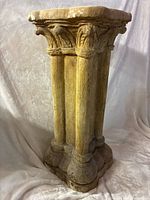 Full view of pedestal showing capital, shafts, base
