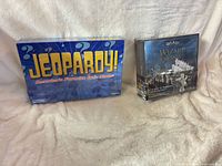 Sealed Jeopardy board game box beside sealed Harry Potter Wizard Chess Set box