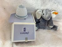 Lladró porcelain bell on original box beside Steiff plush elephant