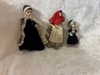 All three dolls side by side showing size and attire
