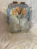 Front view of Barbie doll attached to holographic backing showing gown details